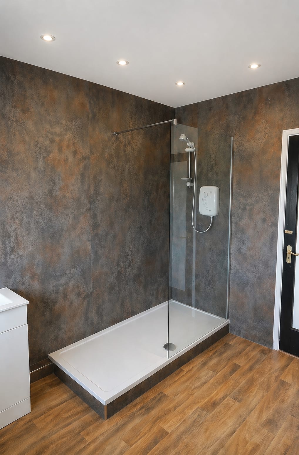 Walk-in shower with bronze-toned wall panels and wood-effect flooring